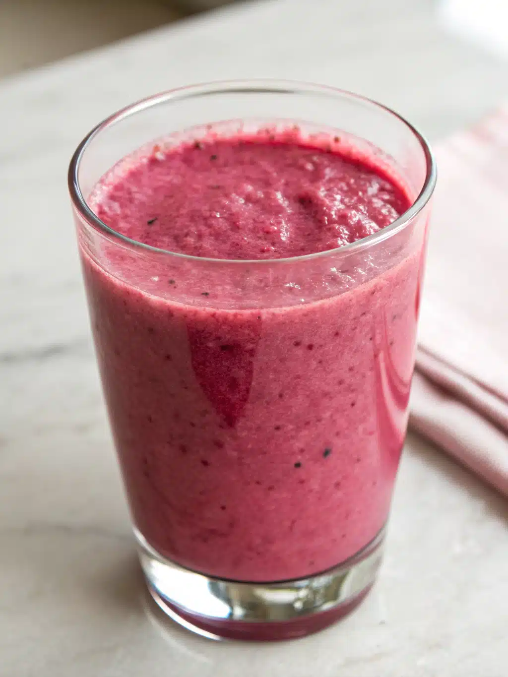 Beet berry smoothie served in a mason jar with a cinnamon rim