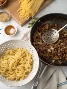 Creamy chili cheese pasta with ground beef and cheddar, topped with sour cream and green onions for a hearty, comforting meal. Ready in 30 minutes!