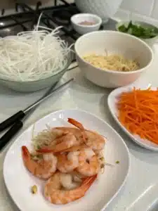 Creamy shrimp noodle bowl with rice noodles, fresh ginger, and lime. Topped with crunchy carrots and sprouts for a light, flavorful meal.