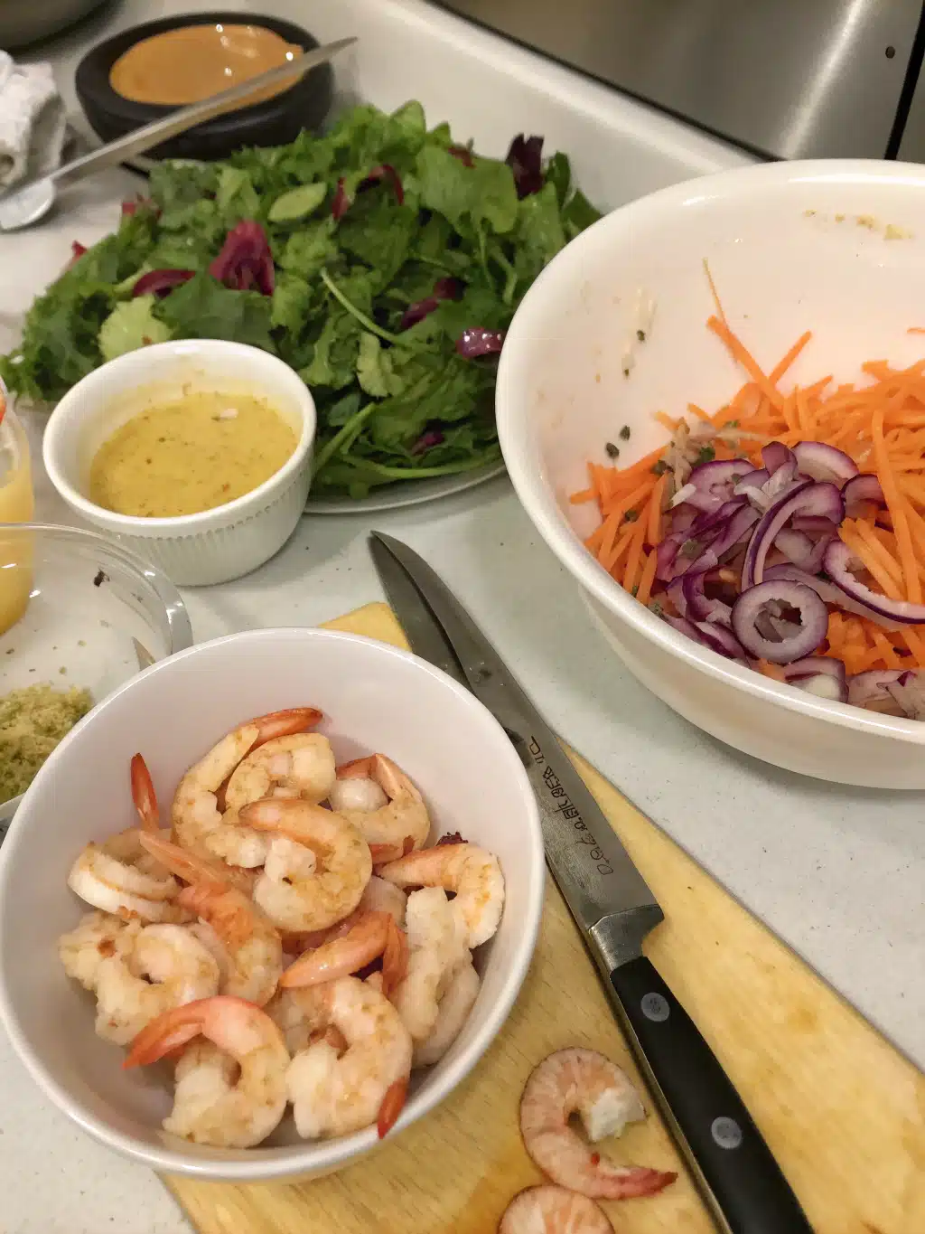 Mixing fresh vegetables for shrimp sesame salad