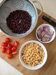 Easy bean salad recipe with chickpeas, black beans, and fresh veggies, tossed in a tangy honey-cumin dressing. Perfect chilled or at room temperature.