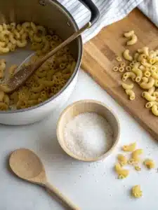 Creamy chili cheese pasta with ground beef and cheddar, topped with sour cream and green onions for a hearty, comforting meal. Ready in 30 minutes!