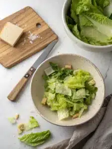Wilted lettuce salad with romaine, dressed in warm garlic butter and topped with hard-boiled eggs. Serve immediately for perfect texture.