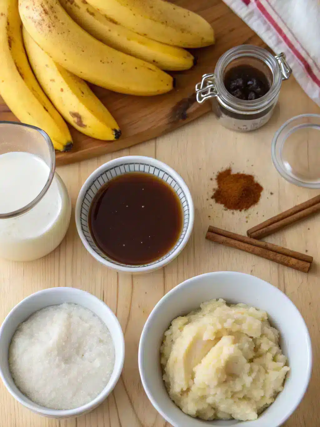 Fresh ingredients for banana bread latte arranged on a rustic table