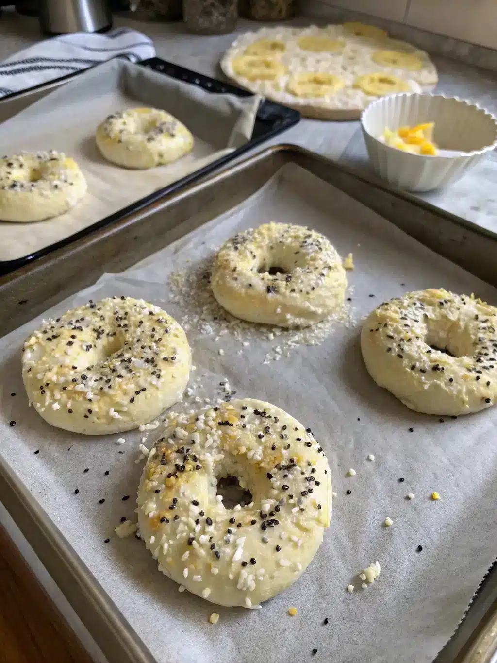 Freshly baked cottage cheese bagels with crispy edges on a wire rack