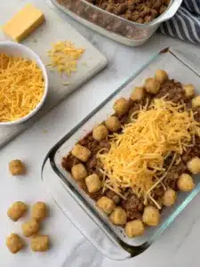 Creamy ground beef cowboy casserole recipe topped with crispy tater tots and melted cheddar cheese—comfort food at its best. Ready in under an hour!