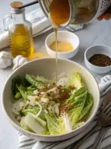 Wilted lettuce salad with romaine, dressed in warm garlic butter and topped with hard-boiled eggs. Serve immediately for perfect texture.