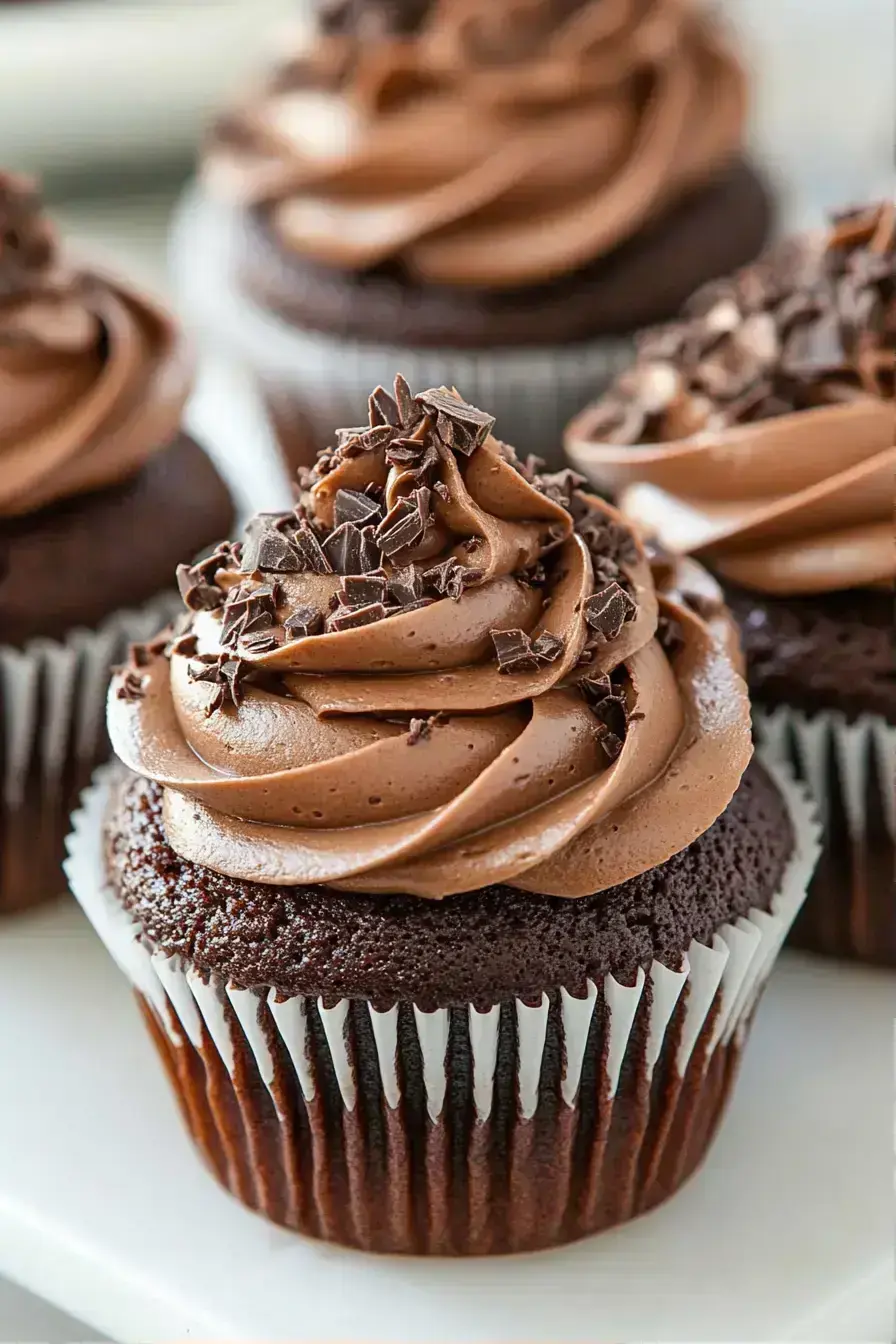 Chocolate cupcake with a sprinkle of powdered sugar, sitting on a plate for a simple dessert