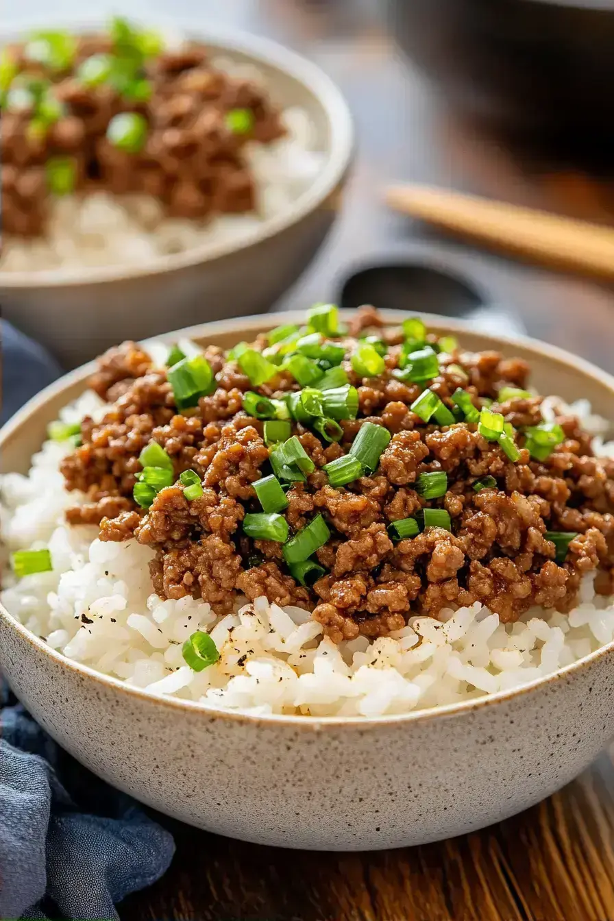 A delicious Ground Beef Rice Bowl with green onions and sesame seeds