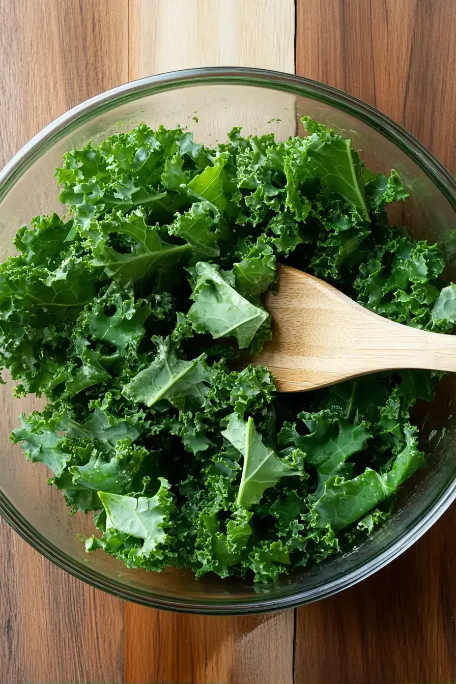 Adding toasted almonds and parmesan to the prepared kale salad