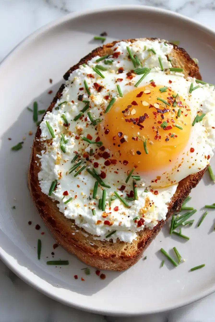 Beautifully plated Egg Ricotta Toast served with fresh coffee and seasonal fruit