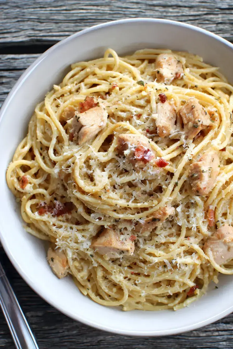 Beautifully plated garlic parmesan chicken spaghetti with fresh parsley garnish