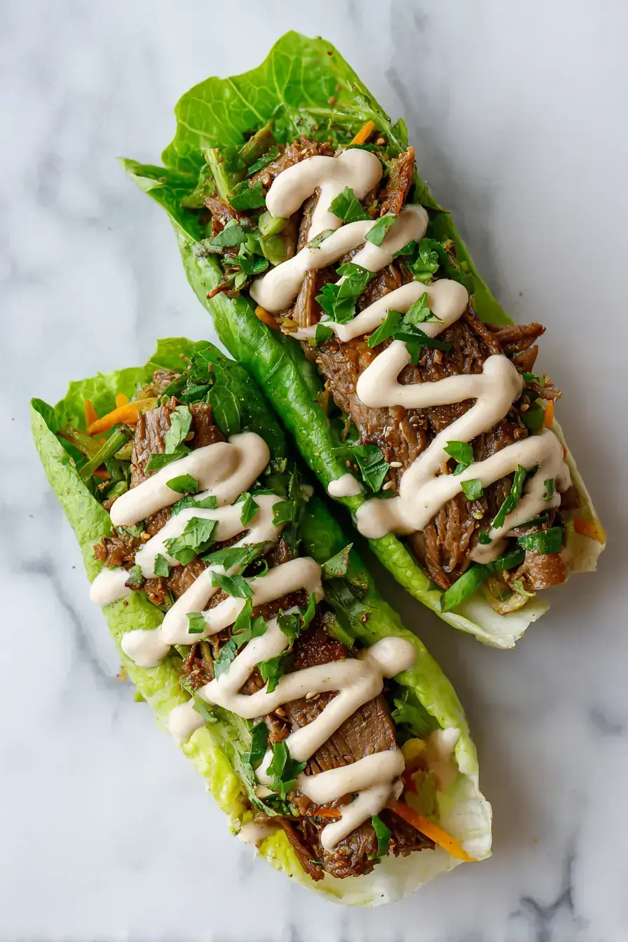 Keto Philly Cheesesteak Rolls arranged beautifully on a platter with fresh herbs